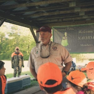 Dave Trahan talks to a group of kids during a NAVHDA Youth Day
