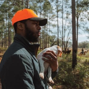 Durrell Smith with a Pointer puppy during a field trial