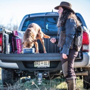 Lee Lee Milner feeding a lab in her truck